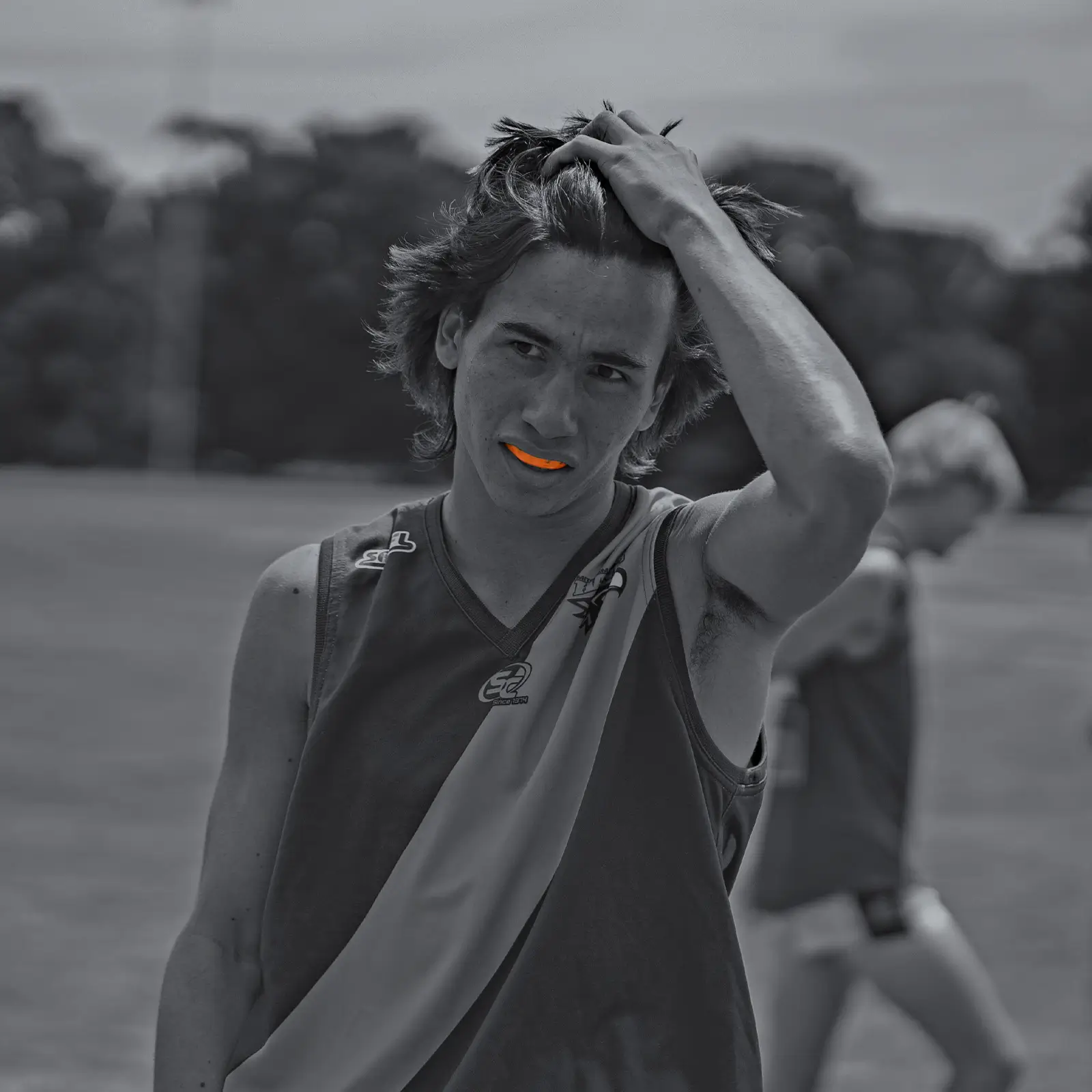 Male sports player wearing an Orange Neomorph Mouthguard